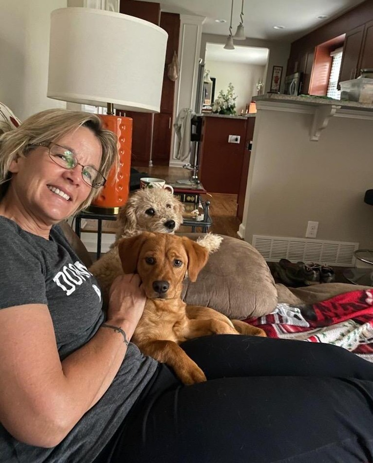 Amy posing with a couple of dogs.